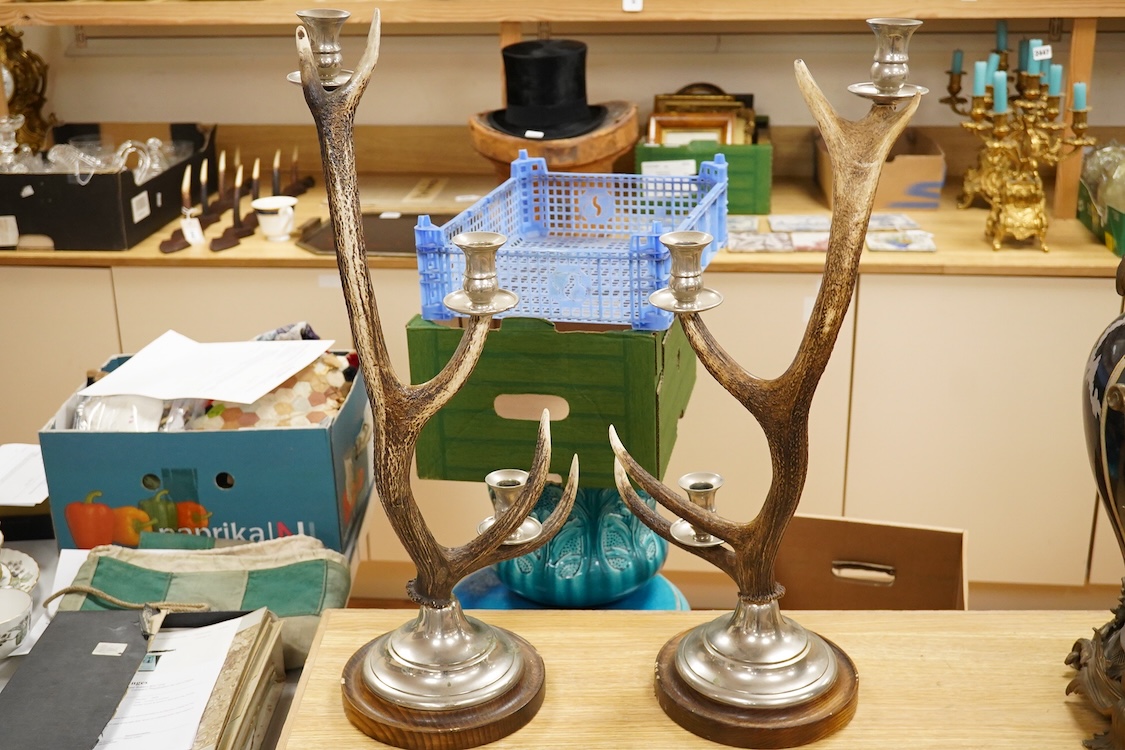 A pair of three light antler candlesticks, 67cm high